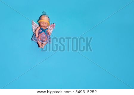 Mockup With A Doll That Has A Renegade On Its Head, Flat Lay. Concept - Contraception As Protection 
