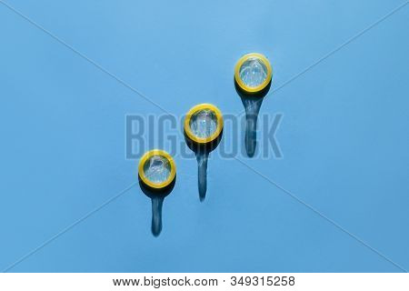 Group Of A Condom On A Blue Background, Flat Lay