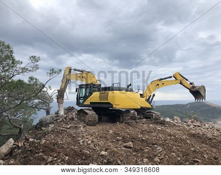 Excavator And Hydrohammer During Road Construction On The Rocky Soils