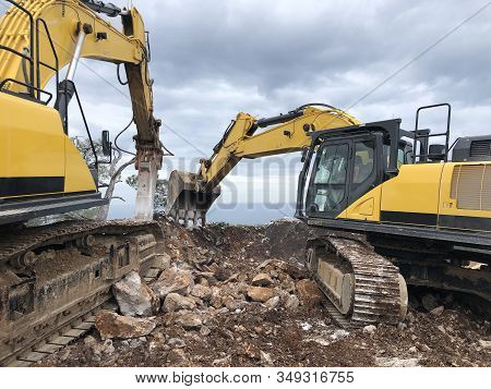 Excavator And Hydrohammer During Road Construction On The Rocky Soils