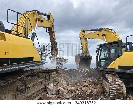 Excavator And Hydrohammer During Road Construction On The Rocky Soils
