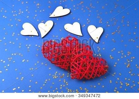 Beautiful Red And Wooden Hearts On The Cornflowerblue Background In The Golden Star Sequins. St Vale