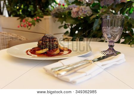 Chateaubriand steak with foie gras and truffle, French dish served on summer patio