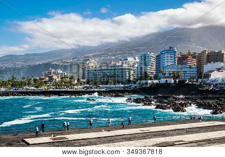 Puerto De La Cruz, Tenerife, Spain - December 18, 2019: Locals Fishing And Watching Giant Waves Cras