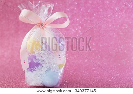 Multi-colored Purple, Pink, Blue, Yellow Easter Eggs In A Transparent Gift Package, Decorated With A