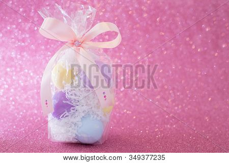 Multi-colored Purple, Pink, Blue, Yellow Easter Eggs In A Transparent Gift Package, Decorated With A