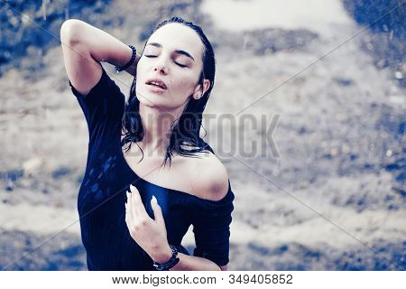 Sexy Beautiful Young Woman Enjoying Summer Rain. Attractive Brunette Woman Wearing Black Bodysuit An
