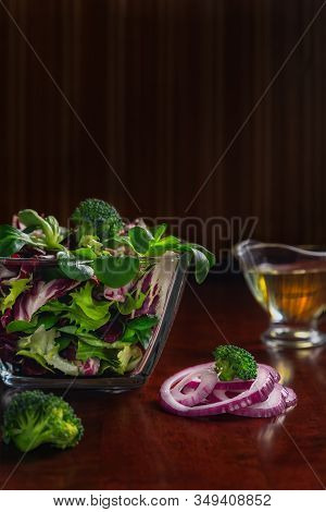 Ingredients For Organic Salad Of Frisse, Broccoli, Radicchio, Onion, Olive Oil. Close Up View.