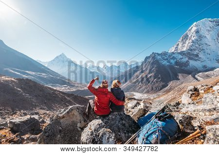 Young Couple Rejoicing On Everest Base Camp Trekking Route Near Dughla 4620m. Backpackers Left Backp