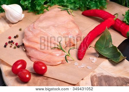 Chicken legs in a red marinade on a cooking board. Pickled raw meat. Dietary meat. Cooking.Raw marinated chicken legs for grill and bbq.Sottilissime