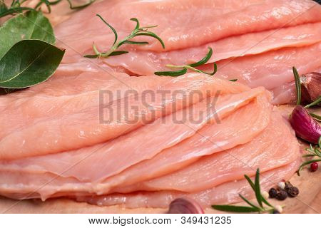 Raw sliced chicken meat close-up. Sotilissimo. Delicious dietary meat. Cooking,food of meat and fillets.Close-up view of raw, fresh, choped and sliced chicken meat.Sottilissime