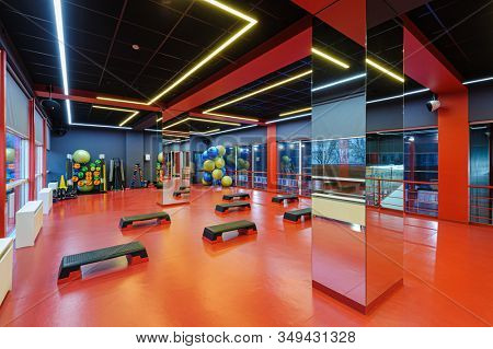 Aerobics gym room interior with decks for step class exercises