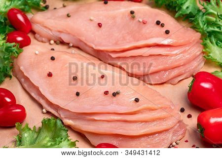 Raw sliced chicken meat close-up. Sotilissimo. Delicious dietary meat. Cooking,food of meat and fillets.Close-up view of raw, fresh, choped and sliced chicken meat.Sottilissime