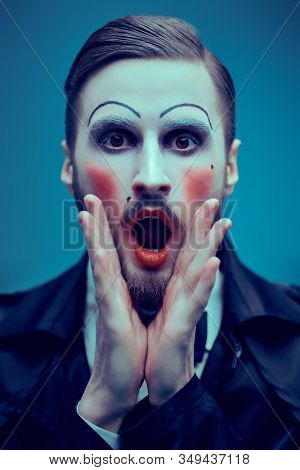 Art and fashion. Portrait of a young man with makeup in the style of the 20s in an elegant suit playing different life roles. Male mime artist.