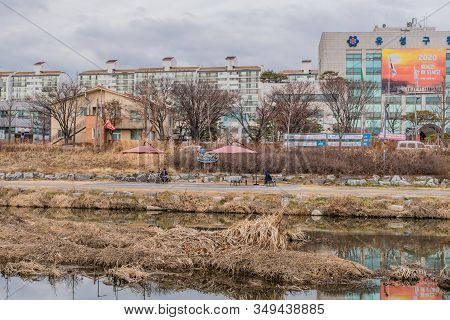 Daejeon, South Korea; January 28, 2020: Two Unidentified Men Sitting On Park Benches At Riverside Bi