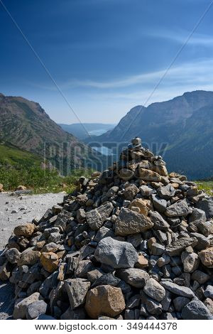 Cairn Stands Above Valley With Mountain Lakes In Distance