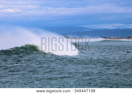 Large Waves Crashing Onshore Including Spray From The Waves Caused By Severe Winds During A Pacific 