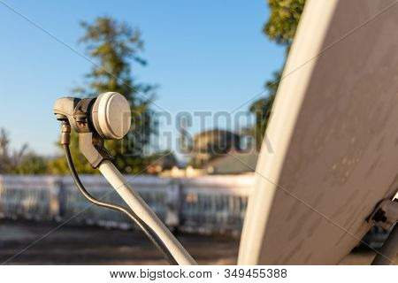 Lnb, Satellite Dish Over The Blue Sky In Background, Selective Focus.