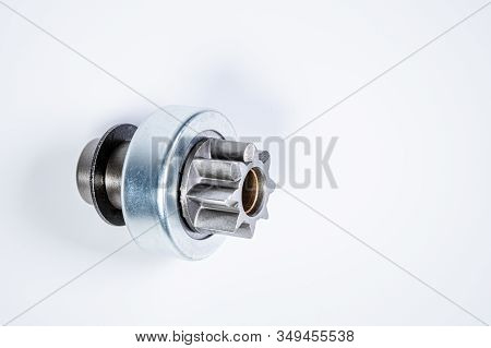 New Spare Parts - Starter Gear Drive For Motor Starter On A Gray Background. Classic Gear Transmissi