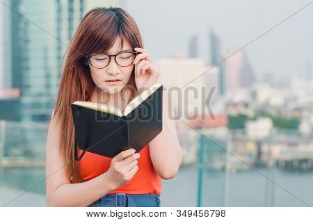 Closeup Portrait Of Attractive Female With Eyeglasses In Hand. Poor Young Girl Has Issues With Visio