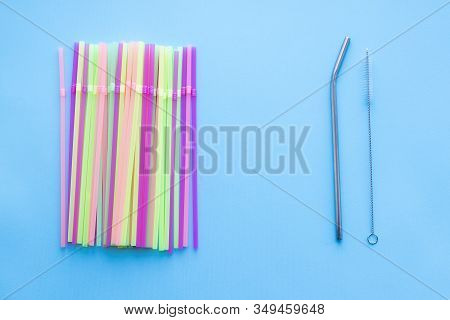 Many Plastic Drinking Straws Vs One Reusable Metal Drinking Straw And Cleaning Brush On A Blue Backg