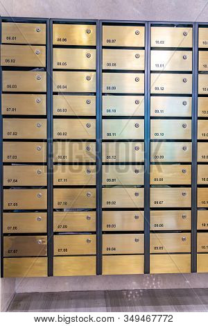 Metallic Mailbox Array In Lobby Of Condominium Building