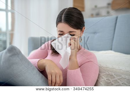 Close Up Of A Young Woman In A Pink Shirt Crying