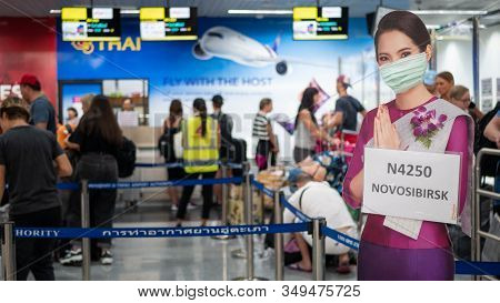 Pattaya, Thailand - February 4, 2020: Air Hostess Welcome Standee Wearing Protect Mask At Check-in A