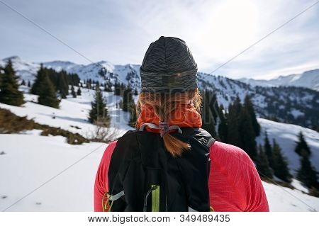 Trail Runner Woman Looking At Mountains On Snow. Woman Athlete Runner Back View