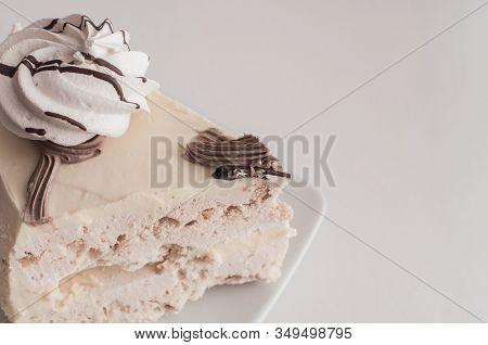 White Cake With Merinques And Cream On The Table