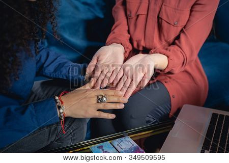 Palmist Looking At The Caucasian Womans Hands