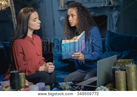 Young Serious Soothsayer Staring At Her Client
