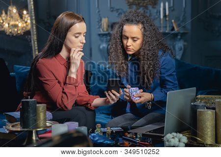 Focused Soothsayer Gazing At Her Clients Cellphone