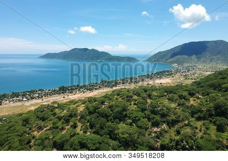 Drone Shot Of The Beautiful Bay With Green Mountains In The Background