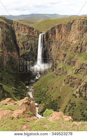 Portrait Shot Of Stunning Waterfall Running Down A Steap Canyon