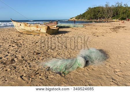 Old Used Fishermen Boats With Fisher Net On Beach