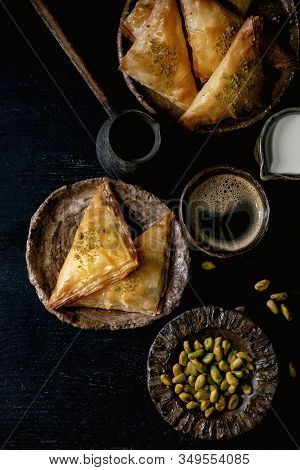 Homemade Turkish Traditional Dessert Baklava With Pistachio Served On Ceramic Plate With Bowl Of Nut
