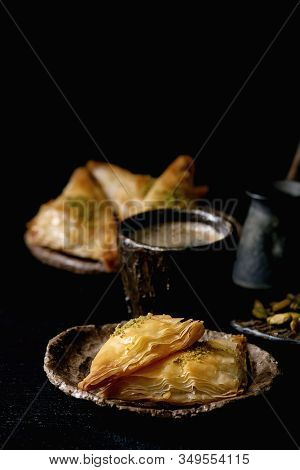 Homemade Turkish Traditional Dessert Baklava With Pistachio Served On Ceramic Plate With Bowl Of Nut