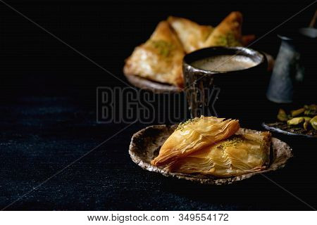 Homemade Turkish Traditional Dessert Baklava With Pistachio Served On Ceramic Plate With Bowl Of Nut