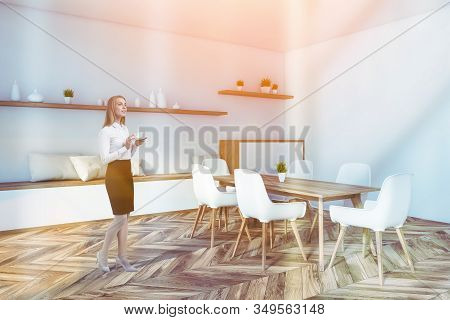 Blonde Woman In White Dining Room With Cabinet