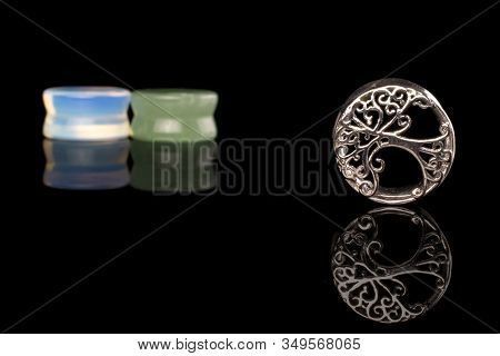 Group Of Three Whole Plug Isolated On Black Glass