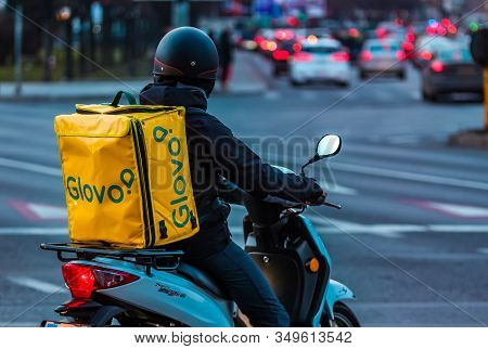Bucharest, Romania - January 28, 2020: A Glovo Food Delivery Courier Delivers Food In Bucharest, Rom