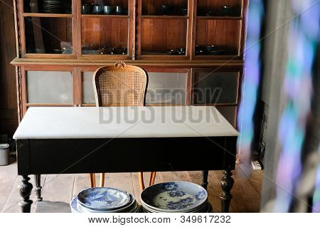 Old Vintage Wicker Rattan Chair & Working Table In Home Office Interior