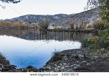 Large Lake Reflecting Autumn Trees Colors And The Mountain