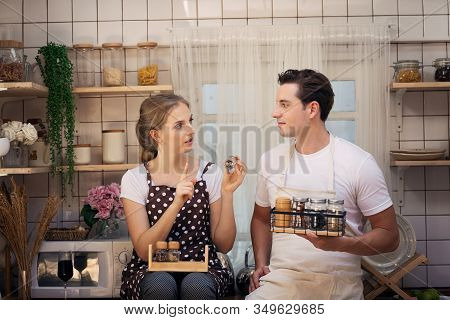 Young Couples Are Happily Choosing The Ingredients Or Raw Material Before Cooking Dinner In The Kitc