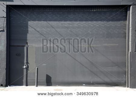 Generic Roll Up Door. Garage or Warehouse with a Roll Up Door. Building entrance with a large steel security door. Los Angeles California or any part of the world uses doors to keep things safe. 
