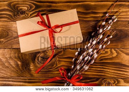 Pussywillow Bouquet And Cardboard Gift Box On Rustic Wooden Table. Top View