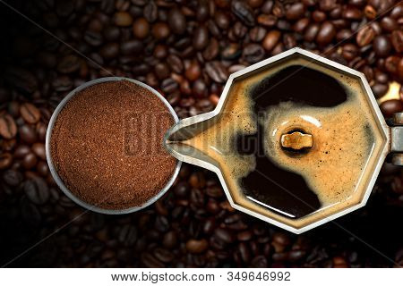 Close-up Of An Open Italian Coffee Maker With Ground Coffee In A Metal Filter, On Many Roasted Coffe