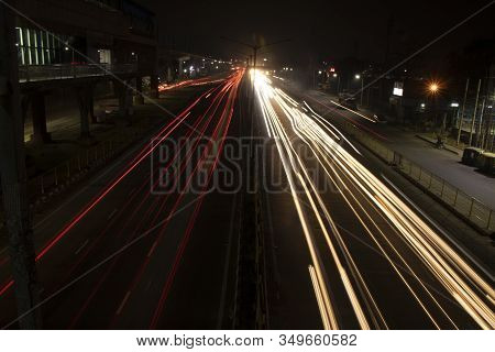 Speed Traffic Light Trails On Highway, Long Exposure, Urban Background And Dark Sky