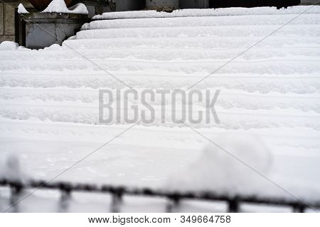 Stairs Covered With Snow From The First Snow Fall Of The Year. Winter Concept, Snowy Staircase Cover